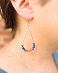 baseball team earring in blue and orange as lifestyle picture