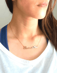 "Baseball Mom" necklace product picture in gold on a woman in white t-shirt