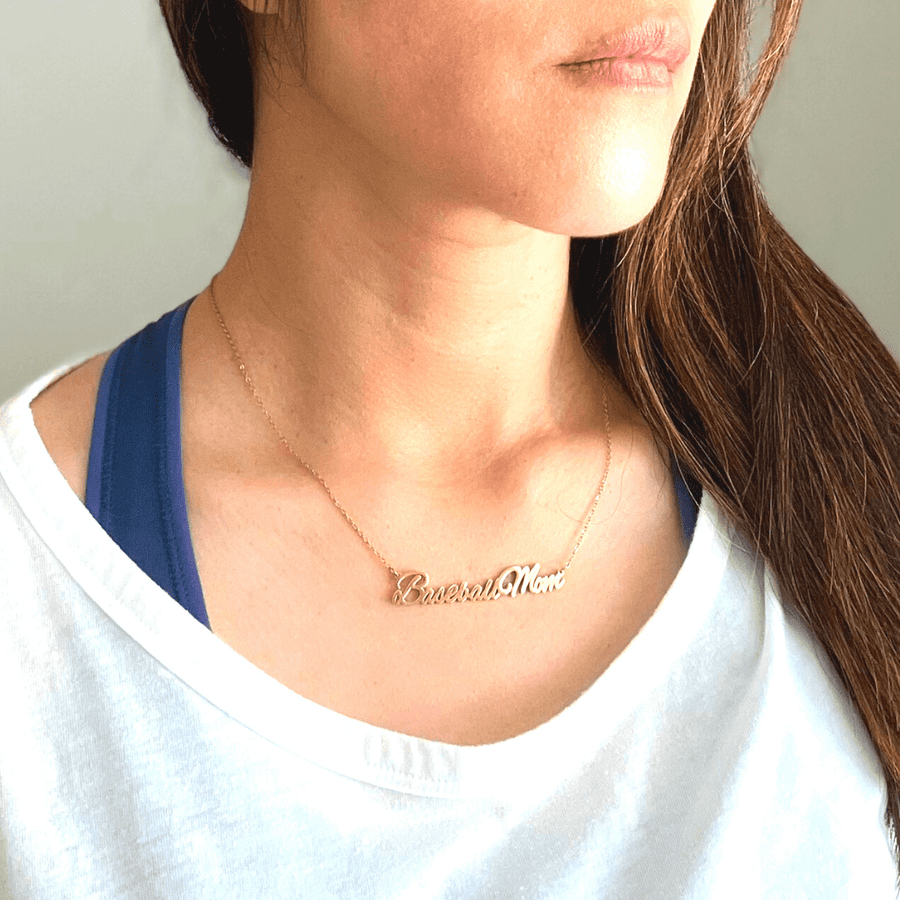 "Baseball Mom" necklace product picture in gold on a woman in white t-shirt
