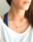 "Baseball Mom" necklace product picture in silver on a woman in white t-shirt