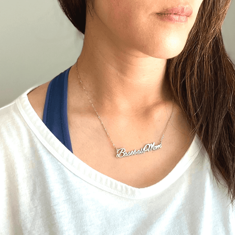 "Baseball Mom" necklace product picture in silver on a woman in white t-shirt