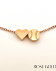 Product close up picture for the Heart and Baseball charm necklace in rose gold